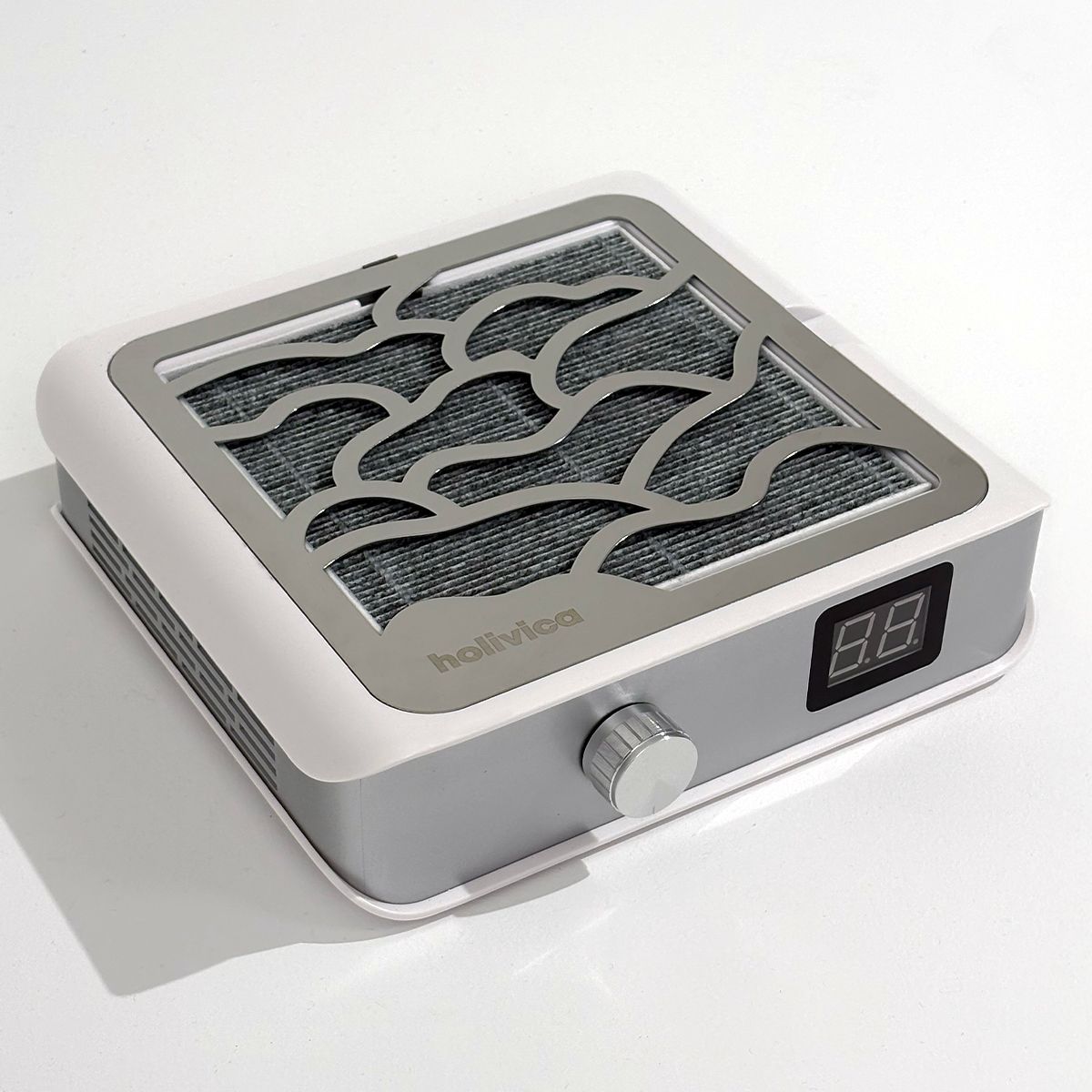Pochłaniacz pyłu Holivica Pro 2 z panelem z metalowym grillem w kształcie fal i cyfrowym wyświetlaczem.